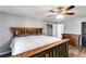 Bedroom featuring a wooden bed frame, wood-look floors, and access to a closet and dresser at 9760 Greenside Way, Douglasville, GA 30135