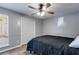 Bedroom with hardwood floors, ceiling fan, large closet, and natural light through the window at 9760 Greenside Way, Douglasville, GA 30135