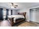 Cozy bedroom featuring wood-look floors, a wooden bed frame, and closet space at 9760 Greenside Way, Douglasville, GA 30135