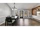 Large dining room with a big table, hardwood floors, and a sliding door to the porch at 9760 Greenside Way, Douglasville, GA 30135