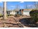 Single story house with beautiful plants and landscaping leading up to the front door at 9760 Greenside Way, Douglasville, GA 30135