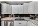 Modern kitchen featuring stainless steel appliances, granite countertops, and black subway tile backsplash at 9760 Greenside Way, Douglasville, GA 30135