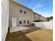 Fenced backyard featuring a concrete patio and a grassy area at 27 Crescent Chase, Dallas, GA 30157