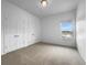 Bright bedroom with neutral carpet, a double door closet and a window with bright light at 27 Crescent Chase, Dallas, GA 30157