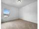 Bright bedroom with neutral carpeting and a large window offering a neighborhood view at 27 Crescent Chase, Dallas, GA 30157