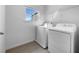 Laundry room featuring new washer and dryer, a window, and a wire shelf at 27 Crescent Chase, Dallas, GA 30157