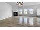 Spacious living room featuring a fireplace and sleek hardwood floors at 27 Crescent Chase, Dallas, GA 30157