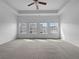 Spacious main bedroom with tray ceilings, carpet flooring, and abundant natural light at 27 Crescent Chase, Dallas, GA 30157