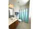 Bathroom featuring a vanity and shower/tub combo with blue shower curtain at 317 Glens Way, Woodstock, GA 30188