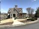 Charming stone-accented home featuring a covered porch and professionally landscaped front yard at 317 Glens Way, Woodstock, GA 30188