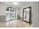 Light-filled entryway with tiled floor, features a full-length mirror and an arched glass door at 395 Pharr Ne Rd # 305, Atlanta, GA 30305