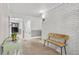 Bright hallway with light-colored brick wall and minimalist decor, featuring tile floors and a wooden bench at 395 Pharr Ne Rd # 305, Atlanta, GA 30305