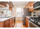 Galley kitchen with wood cabinets, stainless steel appliances, and hardwood floors at 402 Iona Abbey Se Ct, Smyrna, GA 30082