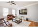 Inviting living room with hardwood floors, neutral paint and a large TV at 402 Iona Abbey Se Ct, Smyrna, GA 30082