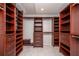 Spacious walk-in closet with custom built-in shelving and drawers for optimal storage at 402 Iona Abbey Se Ct, Smyrna, GA 30082