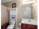 Neutral bathroom featuring a white vanity, framed mirror, cabinet, and shower with patterned curtain at 7881 Wilkerson Ln, Palmetto, GA 30268