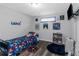 bedroom with wood floors and blue space themed accents, with a mounted flat screen tv on the wall at 7881 Wilkerson Ln, Palmetto, GA 30268