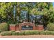 Entrance sign for Wilkerson Mill Park, featuring brick columns, lush bushes and shrubbery, and tall green trees at 7881 Wilkerson Ln, Palmetto, GA 30268