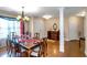 Spacious dining room featuring hardwood floors, chandelier, and natural light from the sheer curtains at 7881 Wilkerson Ln, Palmetto, GA 30268