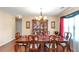 Formal dining room boasts hardwood floors, a chandelier, and a hutch for elegant entertaining at 7881 Wilkerson Ln, Palmetto, GA 30268