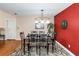 Dining room with decorative rug, chandelier, and accent wall at 7881 Wilkerson Ln, Palmetto, GA 30268