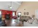 Spacious living room featuring a fireplace, ceiling fan, and hardwood flooring at 7881 Wilkerson Ln, Palmetto, GA 30268