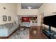 Open floorplan living room with hardwood floors and a view into kitchen area at 7881 Wilkerson Ln, Palmetto, GA 30268