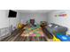 Bright playroom features colorful mats, fun toys, a TV, and playful wall decor at 7881 Wilkerson Ln, Palmetto, GA 30268