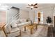 Comfortable living room featuring a fireplace, ceiling fan, and staircase access at 105 Terrace Tay, Peachtree City, GA 30269