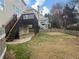 View of fenced backyard from patio with stairs leading to a wooden deck at 1919 Barrett Knoll Nw Cir, Kennesaw, GA 30152