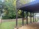 Covered patio overlooks the spacious backyard with a wooden fence at 1919 Barrett Knoll Nw Cir, Kennesaw, GA 30152