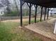 Landscaped backyard with a partially covered patio, mature lawn and rock beds at 1919 Barrett Knoll Nw Cir, Kennesaw, GA 30152