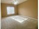 Spacious bedroom with neutral carpet, ceiling fan, and large window at 1919 Barrett Knoll Nw Cir, Kennesaw, GA 30152