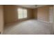 Bedroom with wall-to-wall carpeting, a large window, and a ceiling fan, providing a comfortable and private retreat at 1919 Barrett Knoll Nw Cir, Kennesaw, GA 30152