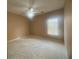 Spacious bedroom with neutral carpet, ceiling fan, and large window at 1919 Barrett Knoll Nw Cir, Kennesaw, GA 30152