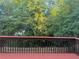 Red deck overlooks backyard with wooded fence at 1919 Barrett Knoll Nw Cir, Kennesaw, GA 30152