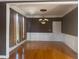 Spacious dining room featuring hardwood floors, wainscoting, and a stylish chandelier at 1919 Barrett Knoll Nw Cir, Kennesaw, GA 30152