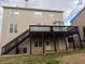 Exterior view of the home featuring a deck, patio, and well-maintained backyard at 1919 Barrett Knoll Nw Cir, Kennesaw, GA 30152