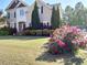 Inviting two-story home with well-manicured lawn, lush landscaping, and vibrant flowering bushes at 1919 Barrett Knoll Nw Cir, Kennesaw, GA 30152