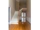 Open foyer with hardwood floors, staircase with white banister, and views into the adjacent rooms at 1919 Barrett Knoll Nw Cir, Kennesaw, GA 30152