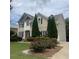 Inviting home exterior with lush greenery, including evergreen trees and roses at 1919 Barrett Knoll Nw Cir, Kennesaw, GA 30152