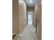 Hallway with neutral carpet and paint, leading to a bright room with a window at 1919 Barrett Knoll Nw Cir, Kennesaw, GA 30152
