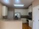 Well-equipped kitchen with white cabinets, stainless steel appliances, and breakfast bar at 1919 Barrett Knoll Nw Cir, Kennesaw, GA 30152