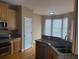 Kitchen with granite counters, stainless sink, and wooden cabinets at 1919 Barrett Knoll Nw Cir, Kennesaw, GA 30152