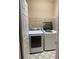 Functional laundry room featuring washer and dryer, storage shelves, and neutral walls at 1919 Barrett Knoll Nw Cir, Kennesaw, GA 30152