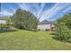 Lawn slopes down from rear patio to the home's tree-lined backyard at 3370 Flagstone Trce, Ellenwood, GA 30294