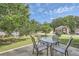 Backyard featuring outdoor dining set, mature landscaping, and view of home's exterior at 3370 Flagstone Trce, Ellenwood, GA 30294