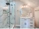 Modern bathroom featuring a glass shower with a marble-style tile surround and a sleek vanity with storage at 3370 Flagstone Trce, Ellenwood, GA 30294