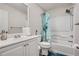 Standard bathroom featuring a shower-tub combo with a decorative curtain, white fixtures, and a simple vanity at 3370 Flagstone Trce, Ellenwood, GA 30294