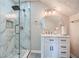 Bathroom featuring a glass-enclosed shower with marble-style tile and a vanity with modern fixtures at 3370 Flagstone Trce, Ellenwood, GA 30294